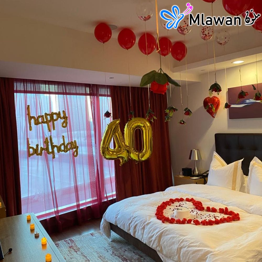 Hotel room decorated with heart-shaped flower petals and red balloons Hotel room decorated with heart-shaped flower petals and red balloons