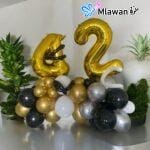 Black and gold number balloon decor for anniversaries