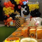 Kids birthday party setup with construction balloons and snack containers