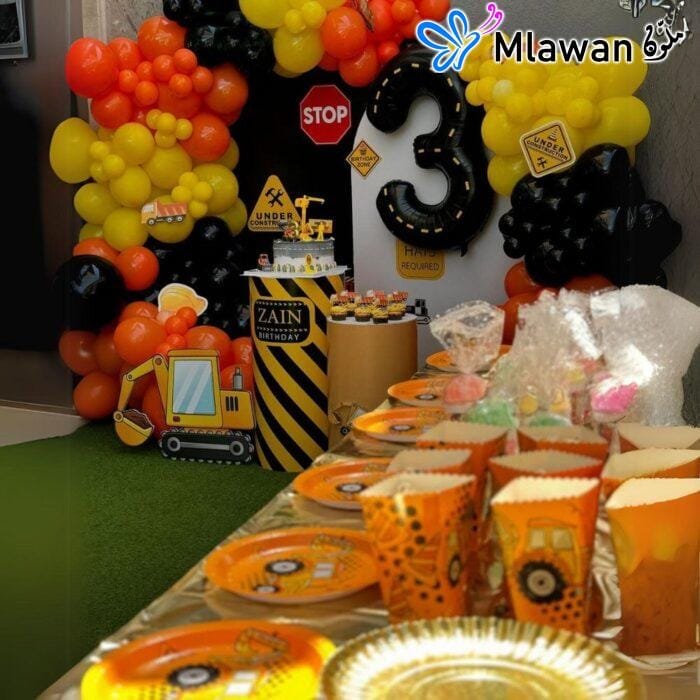 Kids birthday party setup with construction balloons and snack containers