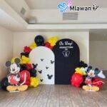Mickey Mouse birthday party decoration setup with backdrops and balloons
