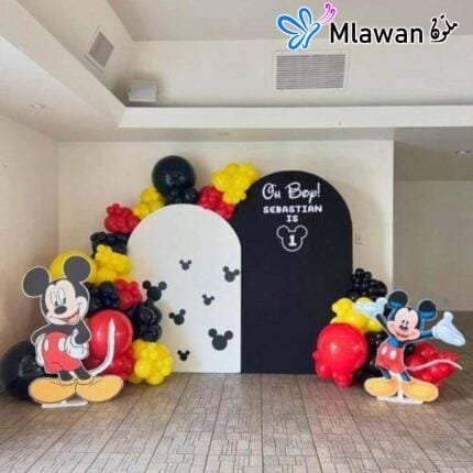 Mickey Mouse birthday party decoration setup with backdrops and balloons