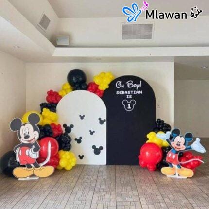 Mickey Mouse birthday party decoration setup with backdrops and balloons