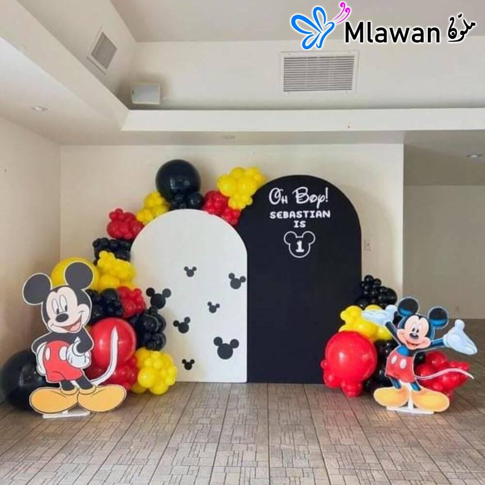 Mickey Mouse birthday party decoration setup with backdrops and balloons Mickey Mouse birthday party decoration setup with backdrops and balloons