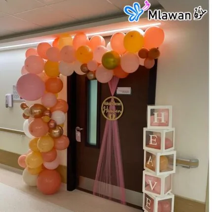 Newborn room decoration with pastel balloons and name sign