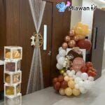 Hospital room setup with teddy-themed door sign and balloons