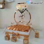 Elegant wedding gift with golden ring and chocolates