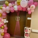 Baby girl hospital room decoration with name boxes and balloon setup