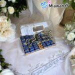 Clear acrylic chocolate bag with golden accents for weddings.