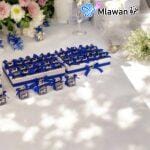 Acrylic favor boxes filled with premium chocolates and customizable name tags for weddings.