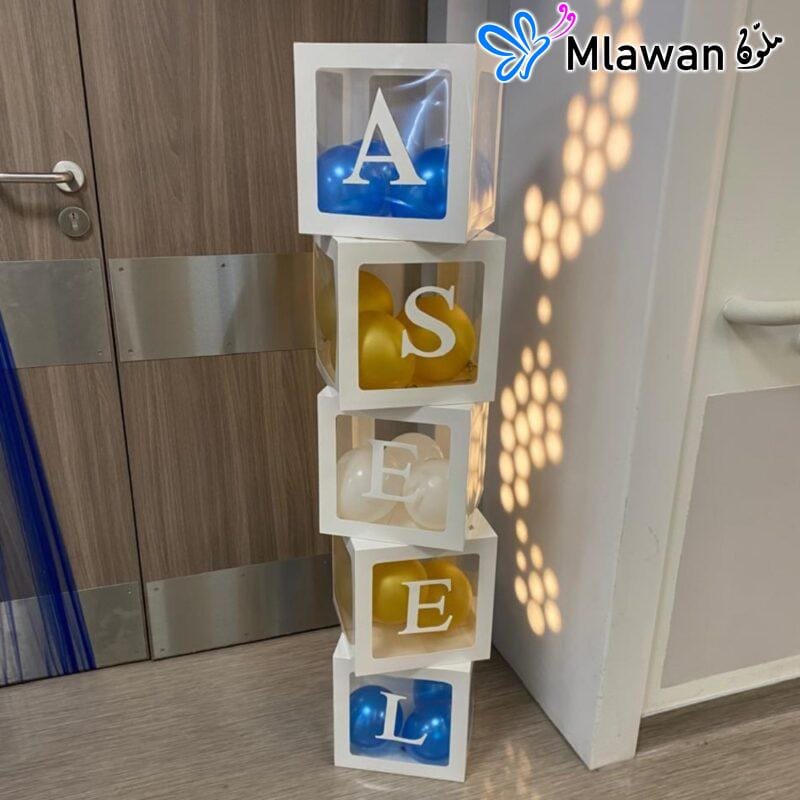 Elegant baby name display boxes with balloons for hospital room decoration.