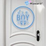 door sign with "It's a Boy" text and footprints