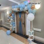festive arc balloon setup in hospital room for baby boy