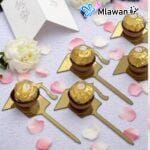 Golden graduation favor with Ferrero chocolate mounted on a decorative stand