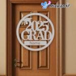 Silver, gold, and black graduation door sign with โCongrats Gradโ text