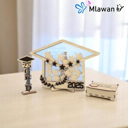 Graduation guest book with pen holder and wooden graduation cap name tags displayed on a table