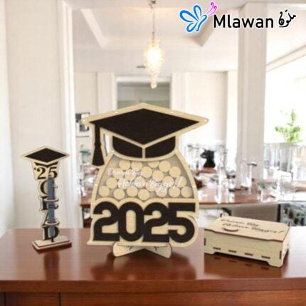Graduation guest book with pen holder and wooden name tags displayed on a table