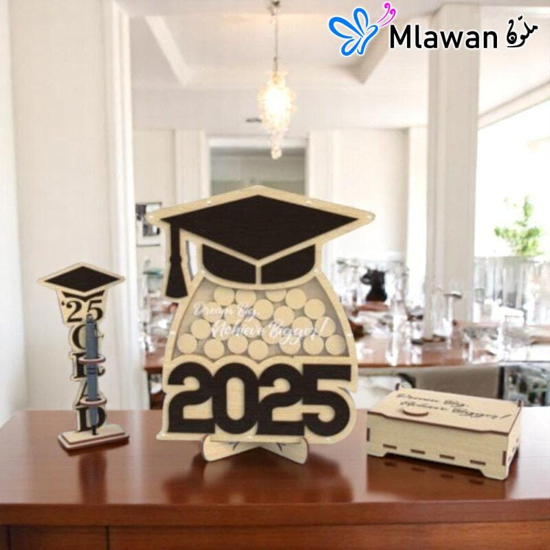 Graduation guest book with pen holder and wooden name tags displayed on a table