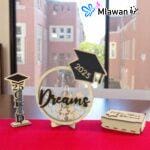 Graduation guest book with pen holder and wooden star name tags displayed on a table