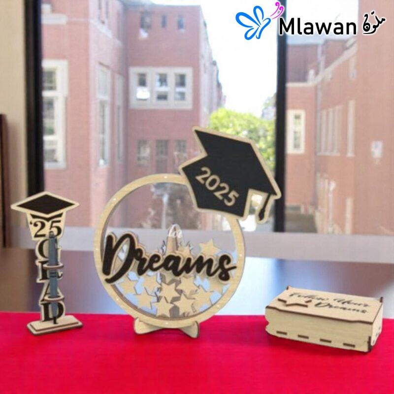 Graduation guest book with pen holder and wooden star name tags displayed on a table