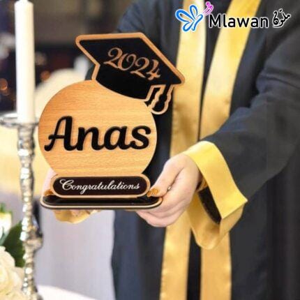 Personalized graduation trophy with graduate's name and cap design on high-quality wood and acrylic base.