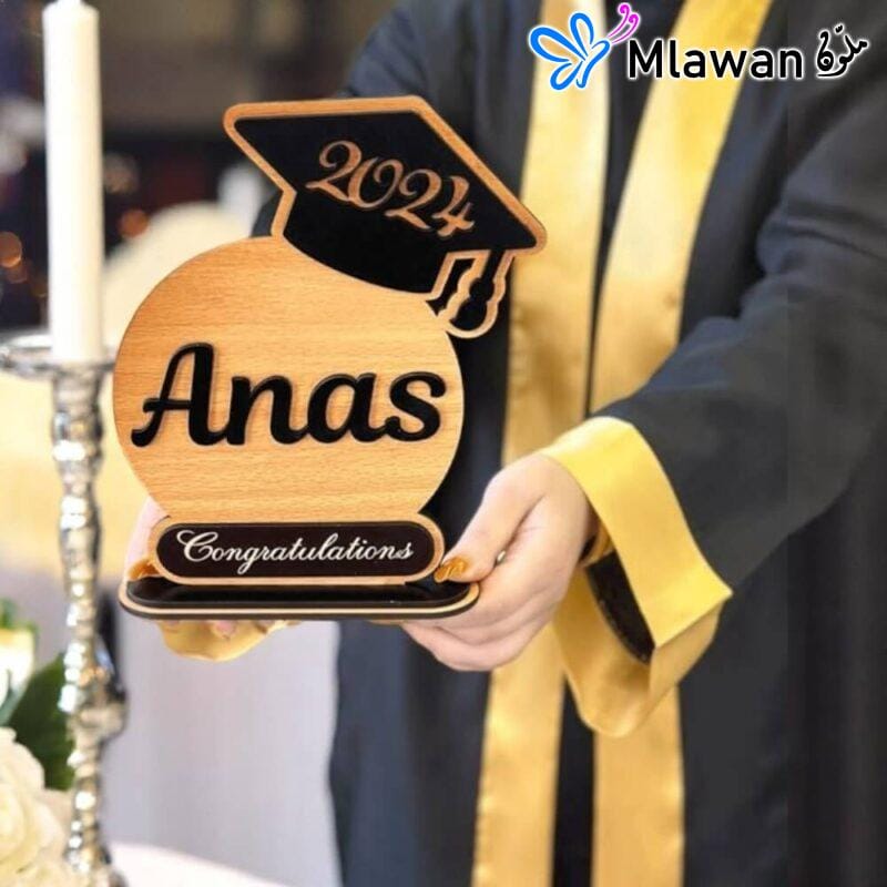 Personalized graduation trophy with graduate's name and cap design on high-quality wood and acrylic base.